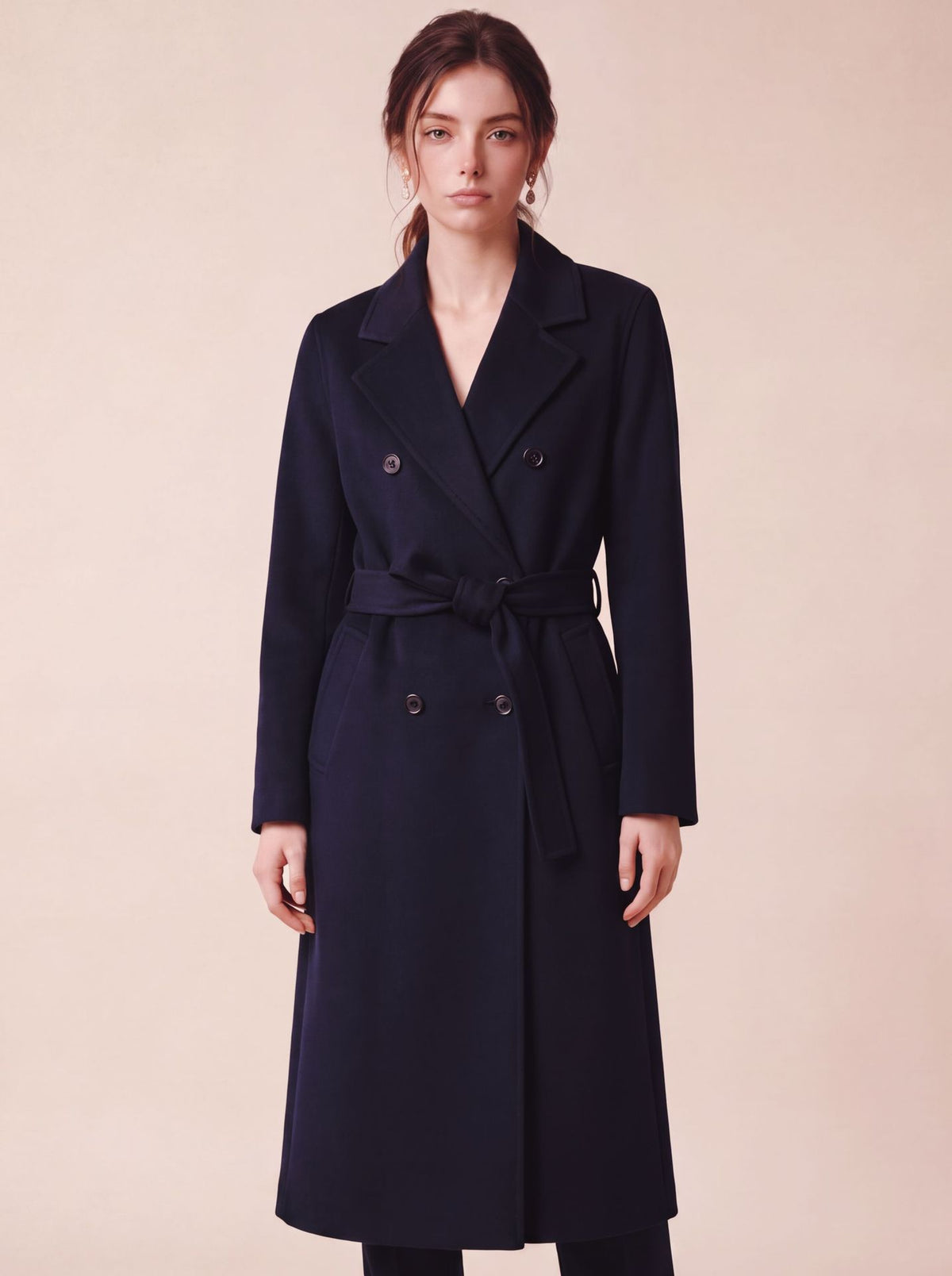 Long navy double-breasted wool coat with wide lapels and tied belt