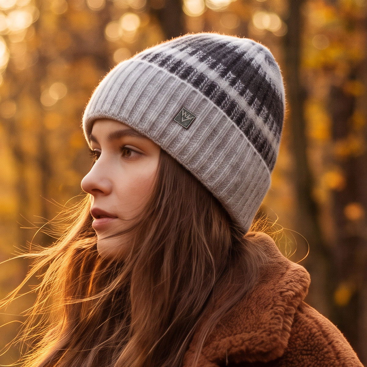 Light gray ribbed knit beanie with dark plaid stripe pattern and small logo patch