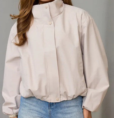 Light apricot women’s short casual jacket with stand collar and button front