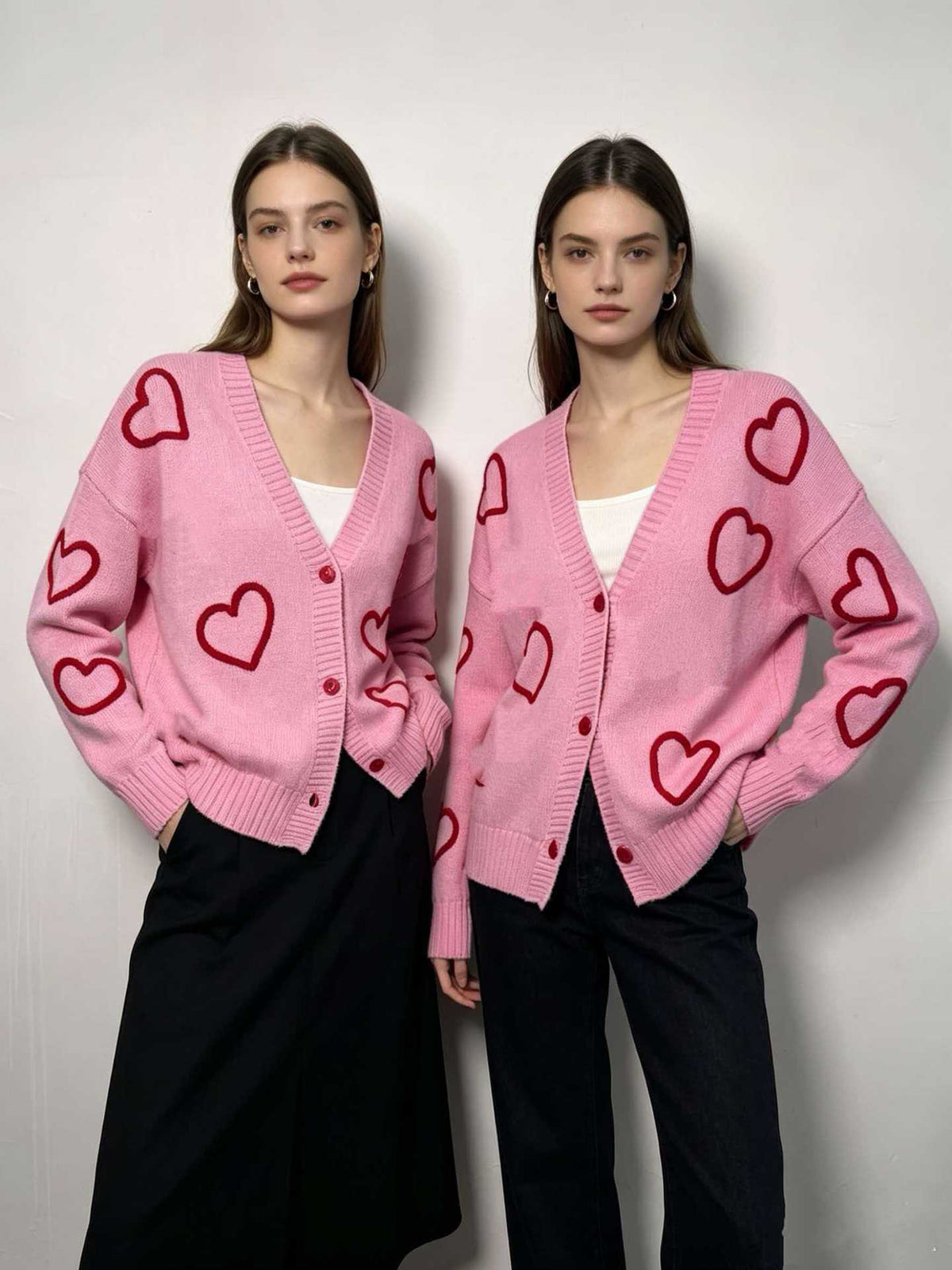 Pink V-neck button-front knit cardigan with red heart motifs