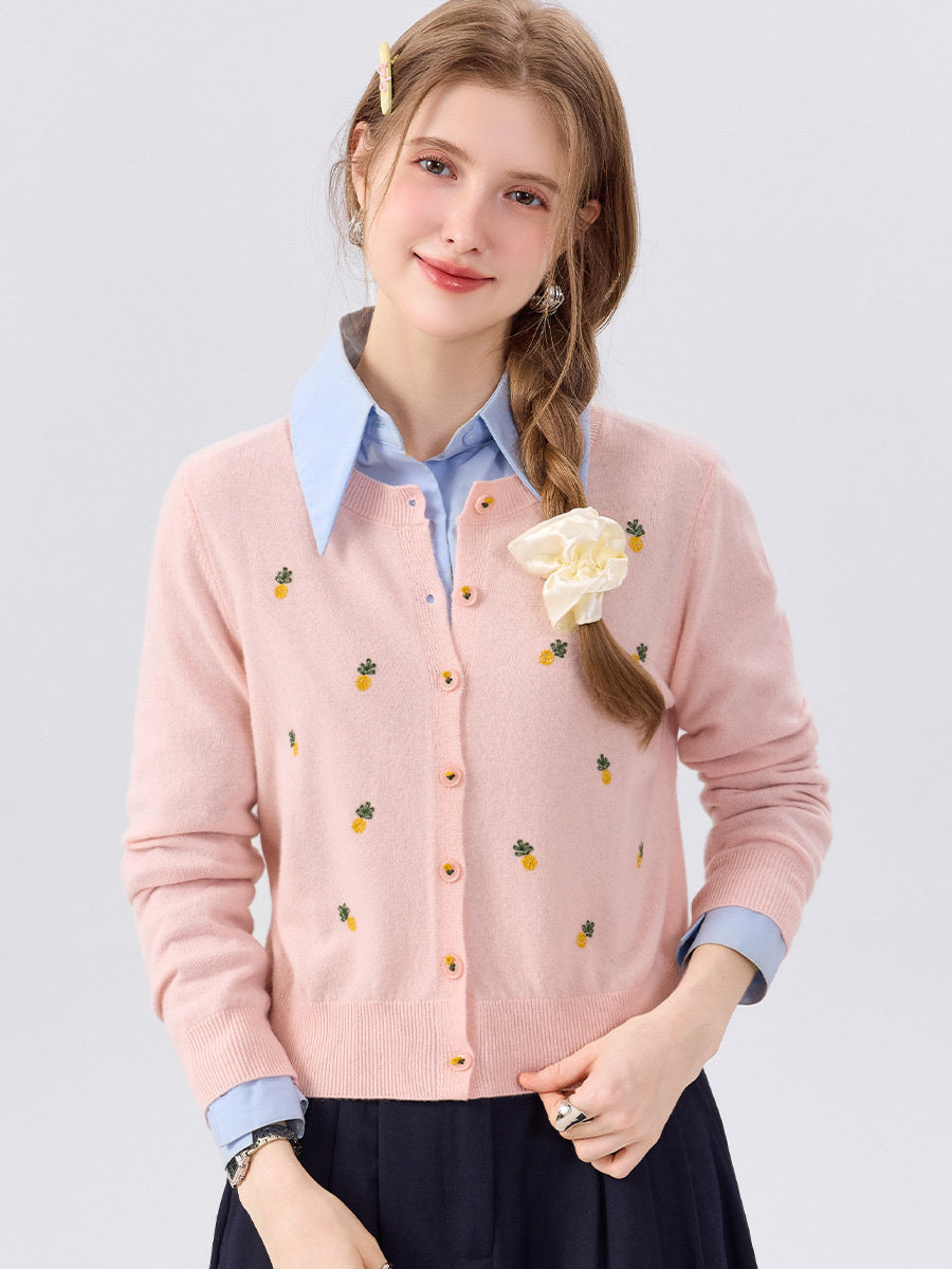 Light pink cardigan sweater close-up, round neck, button-front, long sleeves, fruit print
