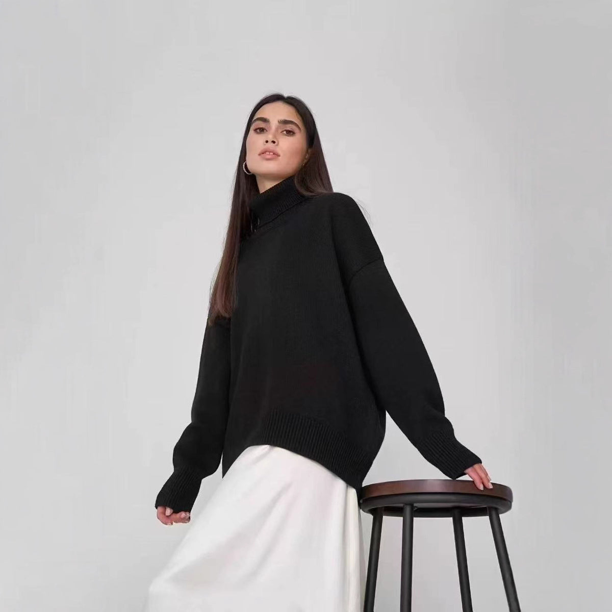Oversized black turtleneck sweater with ribbed cuffs and high roll neck
