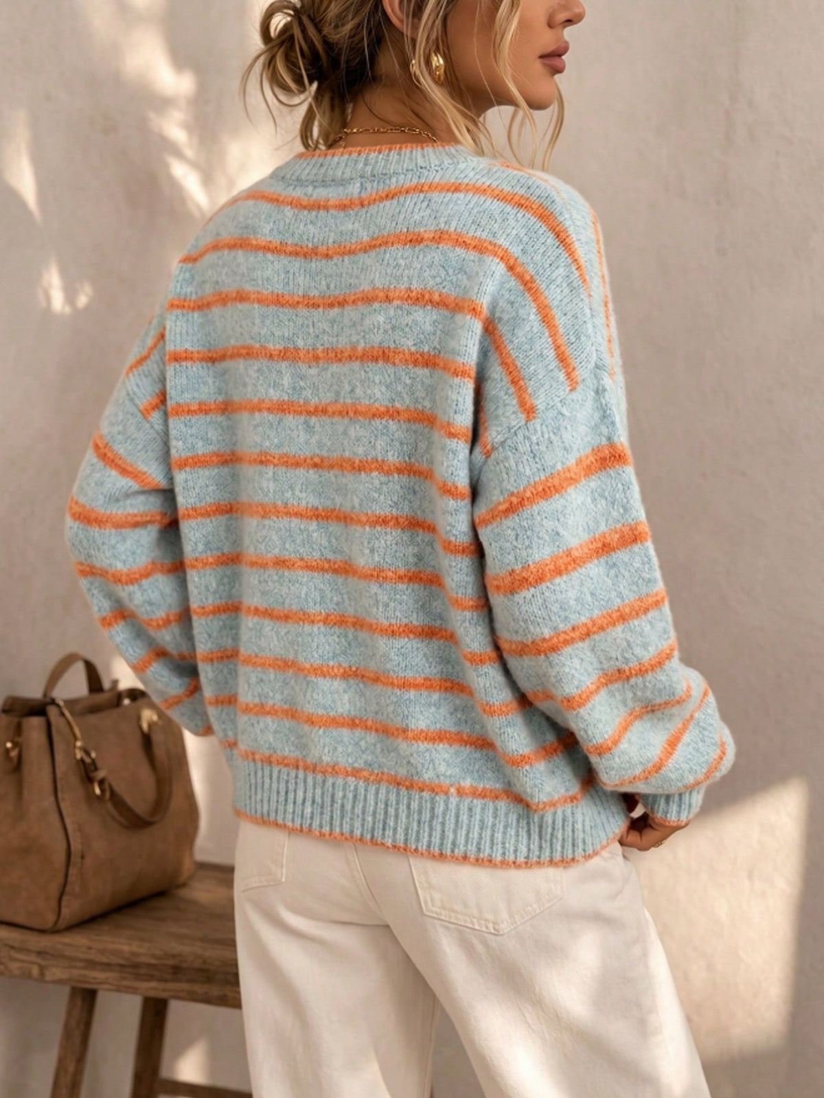 Light blue striped knit cardigan sweater with orange stripes, crew neck back view