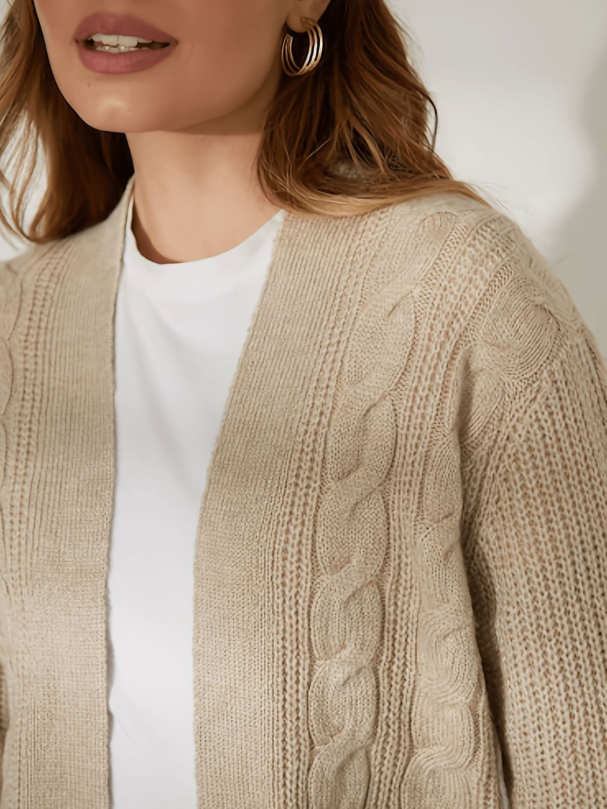 Khaki cable-knit cardigan close-up with open front and vertical braided texture