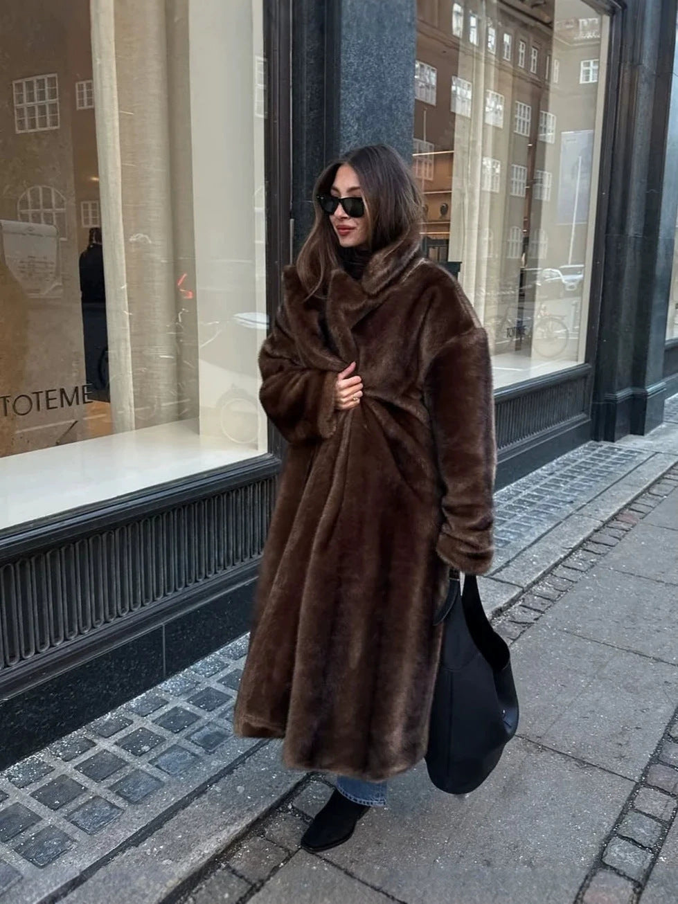 Dark brown faux fur long coat with wide collar and relaxed fit, full length