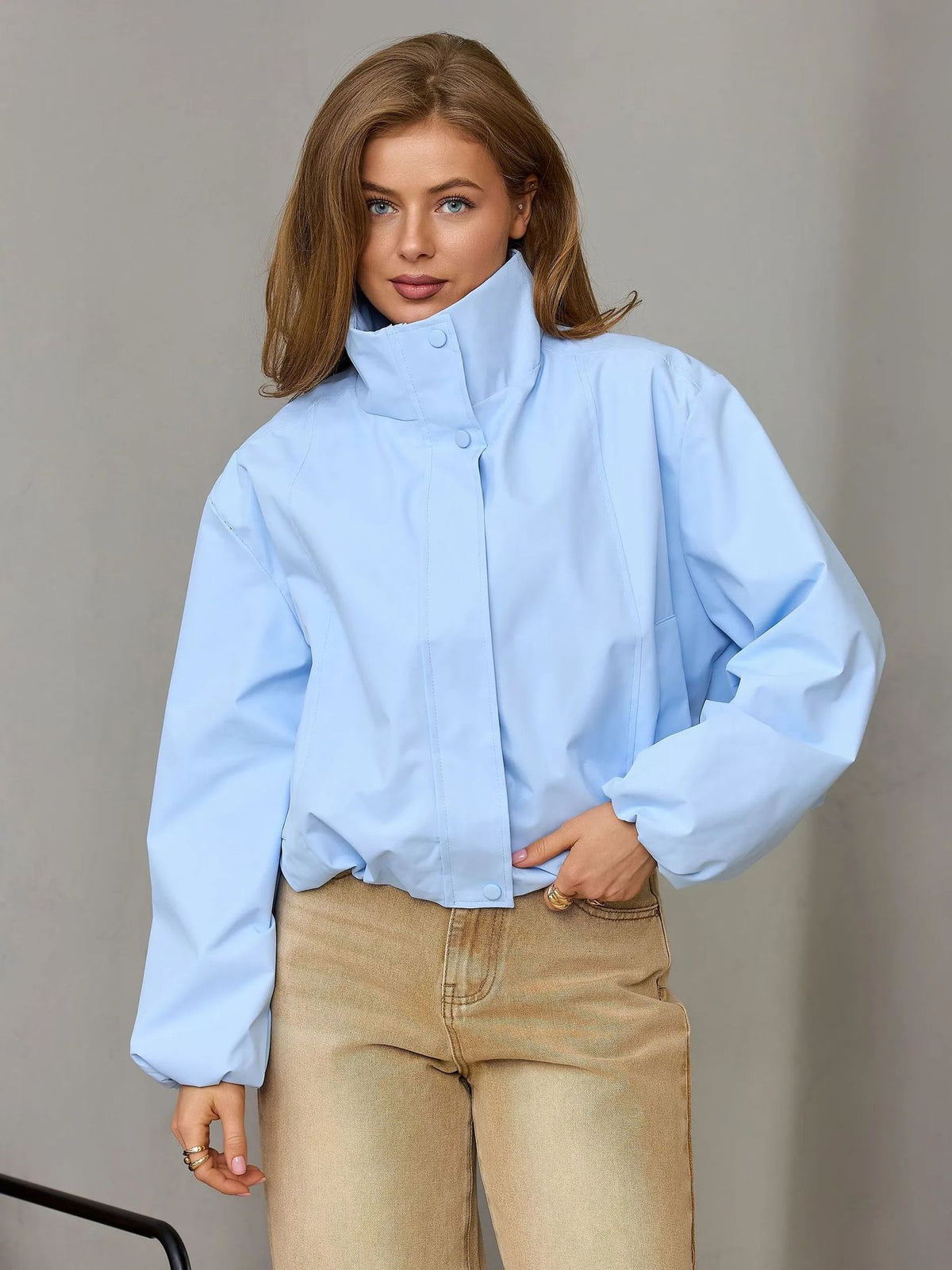Light blue women’s short casual jacket with stand collar and button front