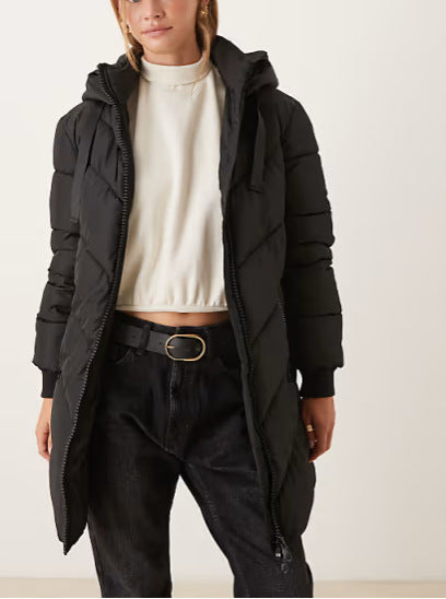 Black long puffer down jacket with full-length zipper and hood, side pockets.