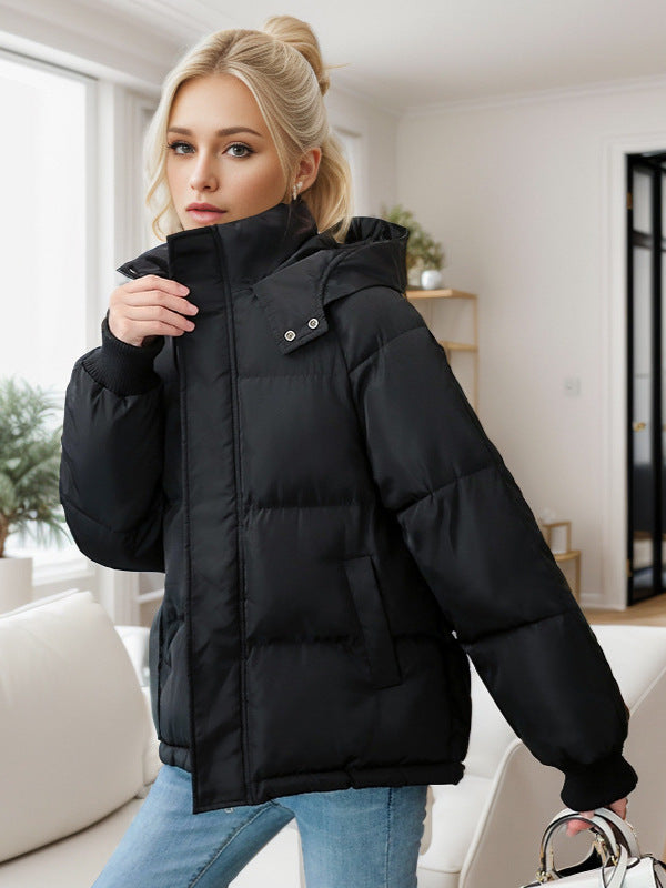 Black cotton puffer jacket with hood, snap trim, and zip front