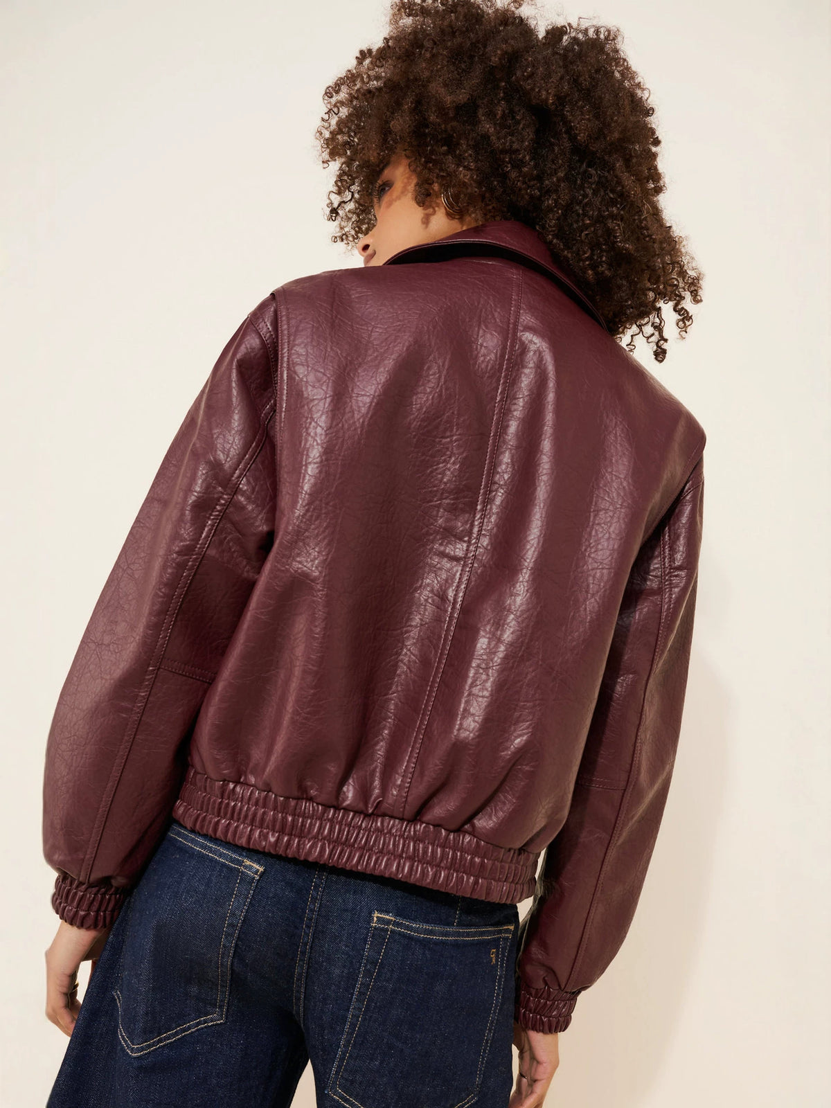 Burgundy faux leather bomber jacket back view with ribbed cuffs and elastic hem