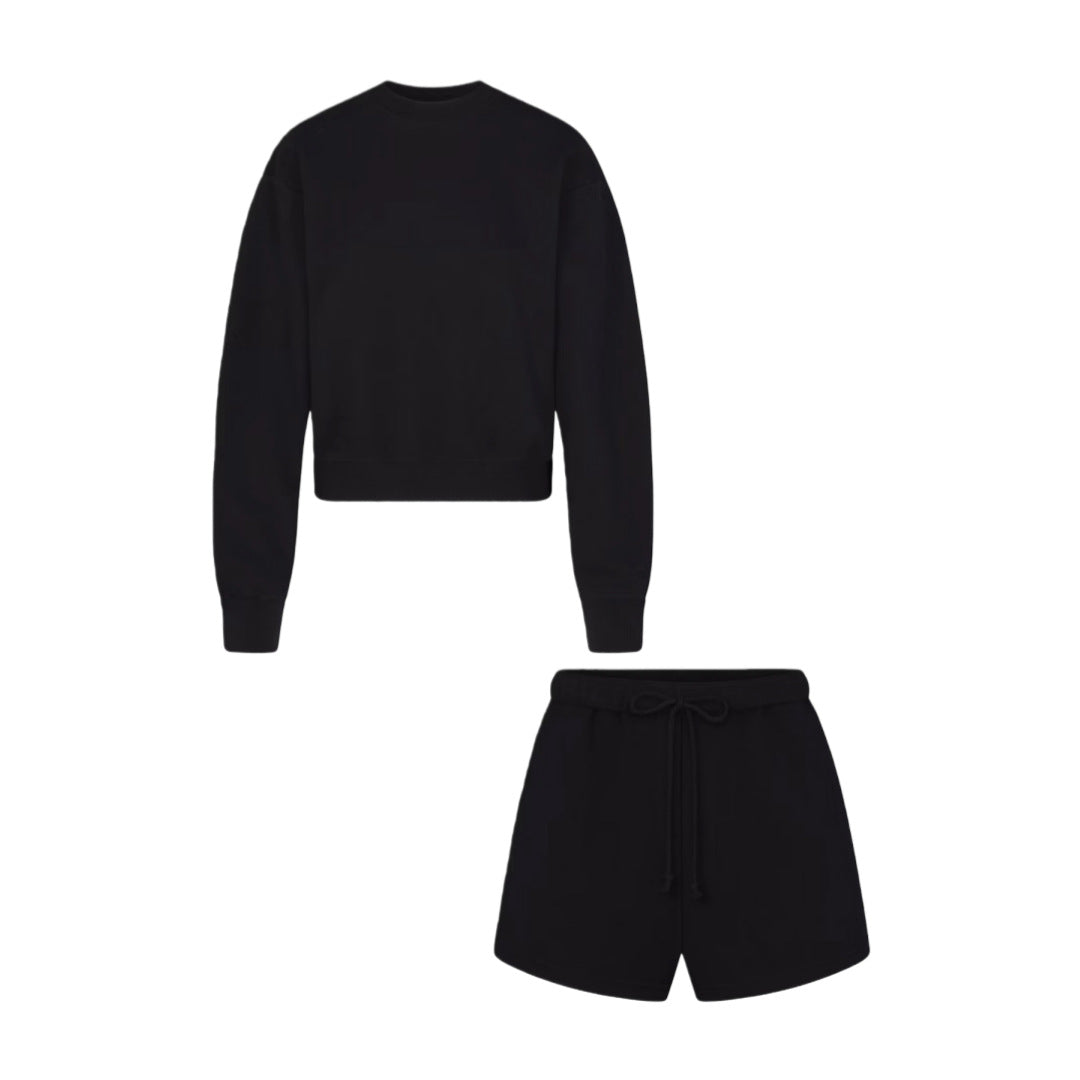 Women’s black two-piece set: cropped sweatshirt and matching shorts with drawstring waist.