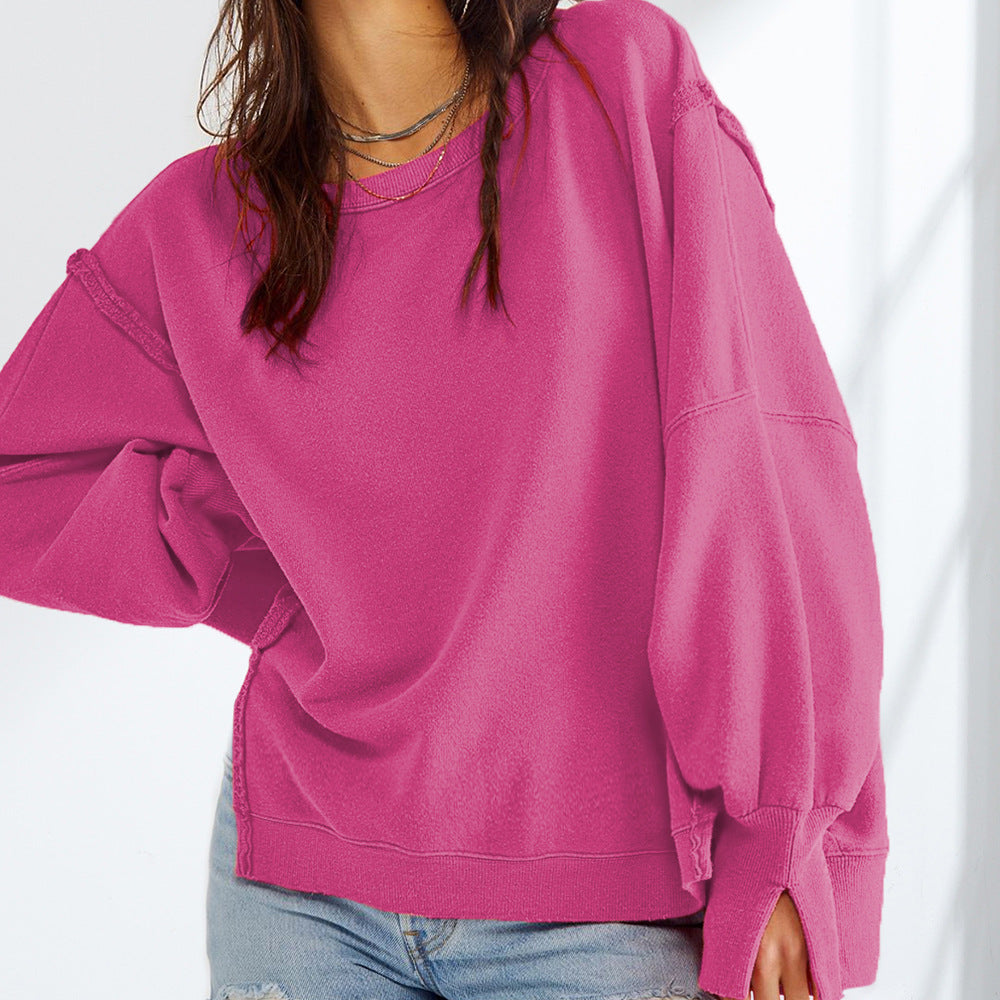 Rose pink sweatshirt detail showing a crew neck, oversized sleeves, and split cuffs