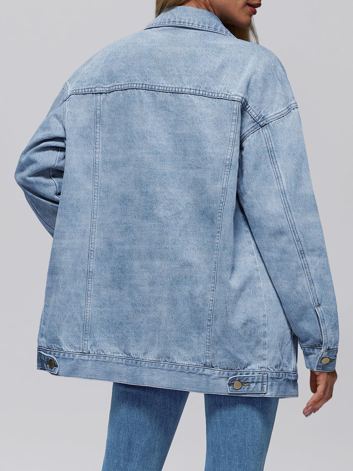 Light blue denim jacket back view with button cuffs and wide yoke stitching