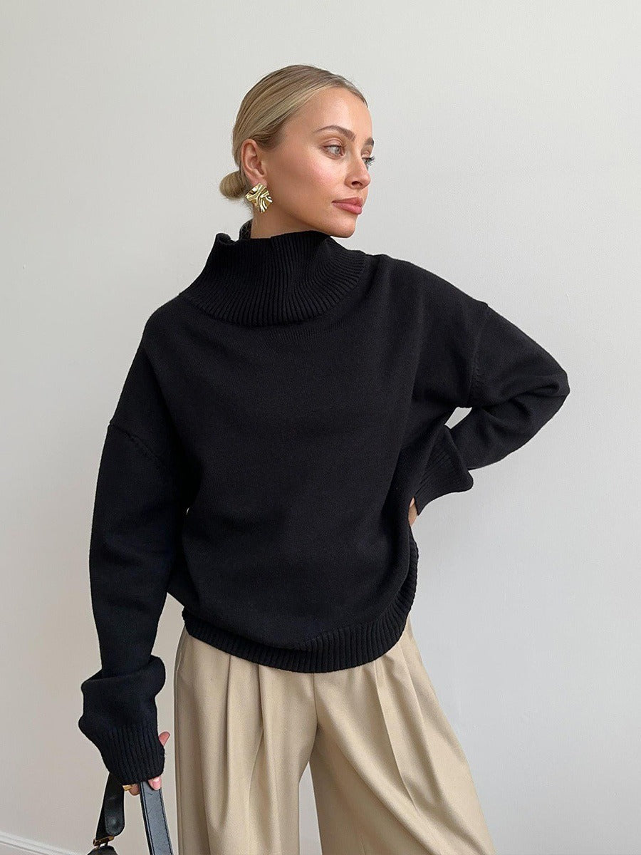 Loose turtleneck knit sweater in black, ribbed turtleneck and cuffs, relaxed fit.