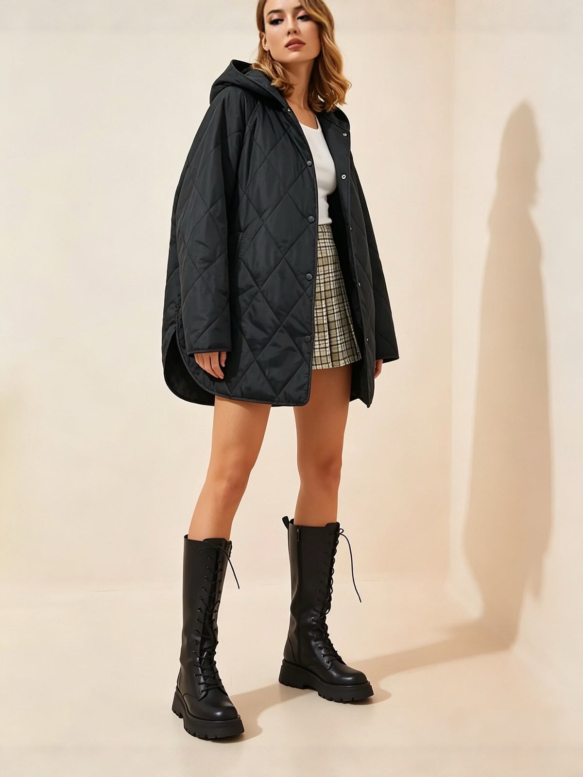 Black hooded quilted cotton coat, front view with snap buttons and side pockets