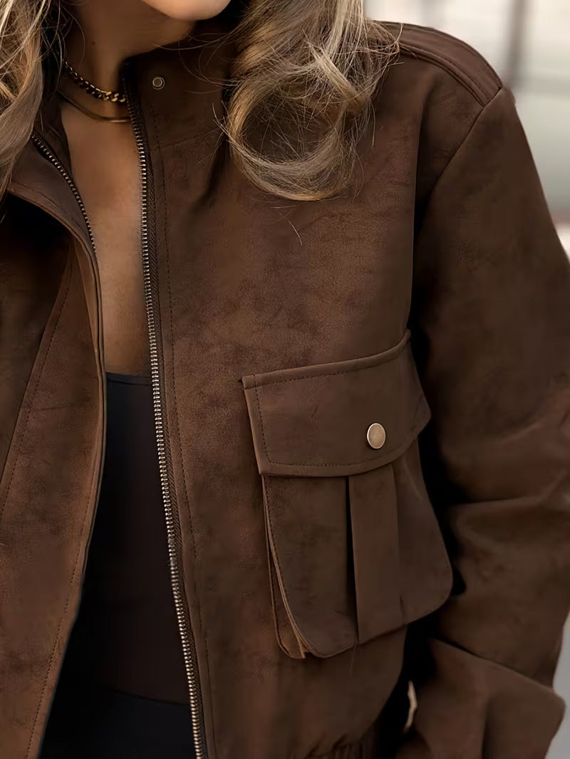 Close-up of the brown suede-texture jacket's zip front and snap-button flap pocket