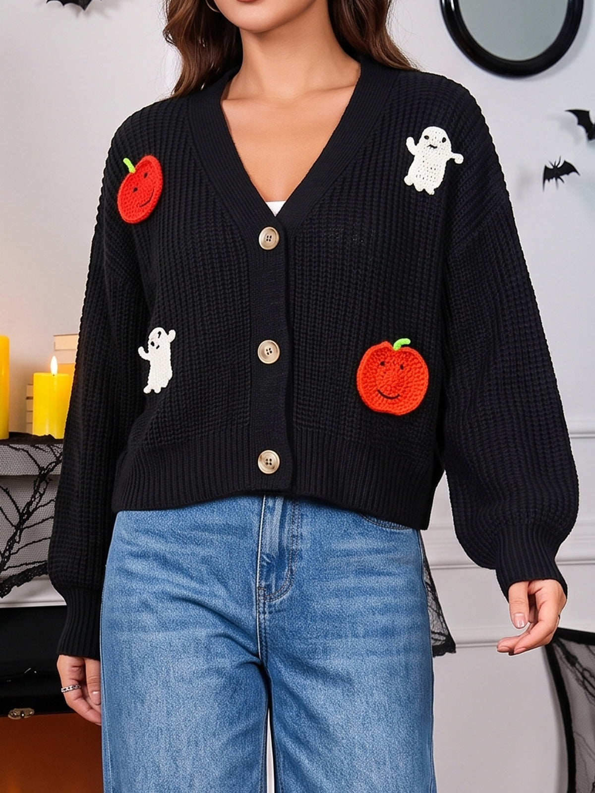 Black knitted cardigan with long sleeves, button front, red pumpkins and ghost motifs