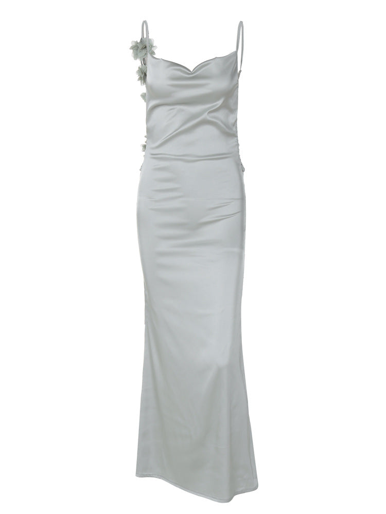 Light green satin long dress with spaghetti straps and small floral embellishment on strap