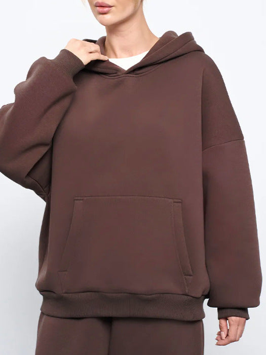 Brown women’s hooded sweatshirt with front kangaroo pocket and relaxed long sleeves
