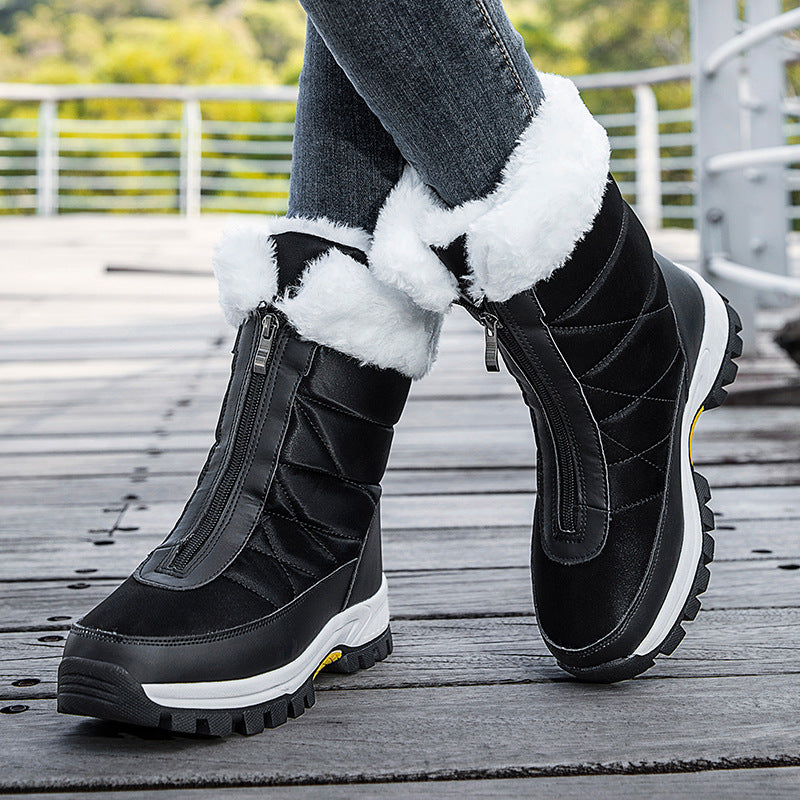 Black snow boots with white faux-fur cuffs, side zippers, thick tread sole