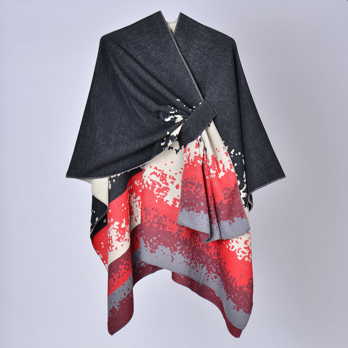 Faux cashmere print shawl, dark charcoal top with red and white splash pattern, draped.