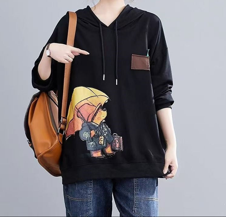 Black pullover hoodie with hood, drawstrings, cartoon front graphic, and front pocket