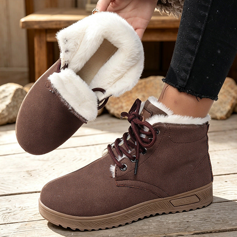 Brown fleece-lined lace-up ankle boots with thick lugged soles; lining shown folded out.