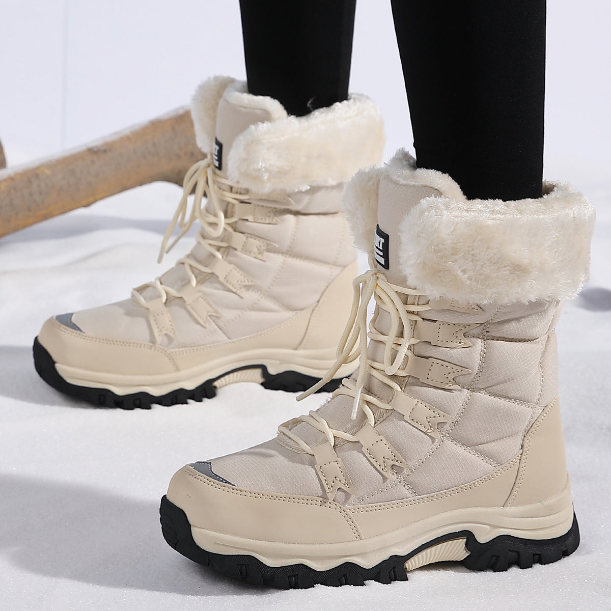 White lace-up snow boots with faux fur cuffs and thick tread sole