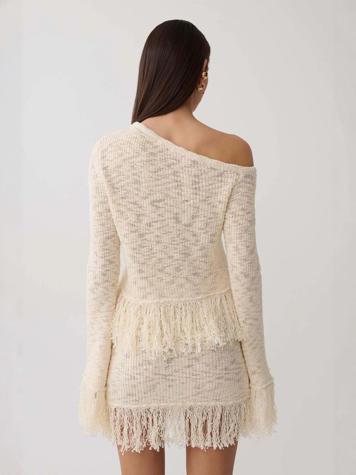 Apricot hollow-knit off-shoulder sweater top with long sleeves and layered fringe hem, back view
