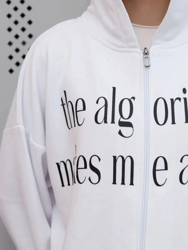 White hoodie close-up: front zip pull with black printed slogan on chest