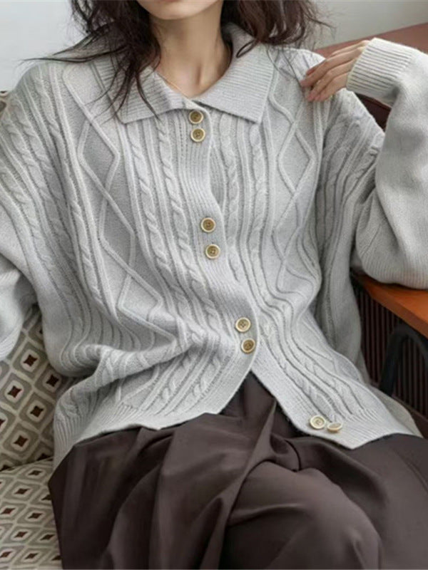 Light gray cable-knit cardigan with pointed collar and button front, worn seated