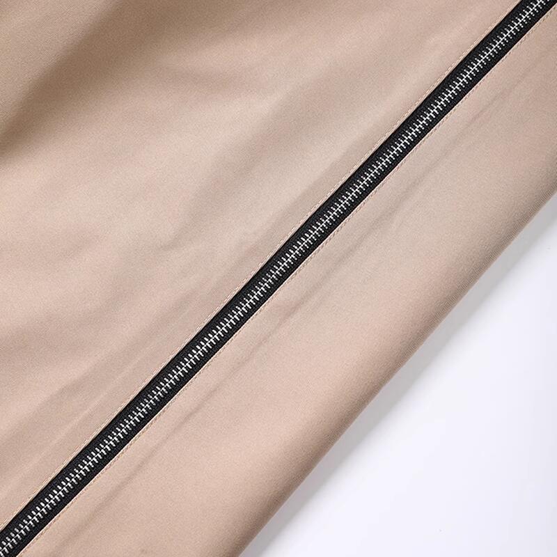 Khaki coat zipper with black trim along the side seam