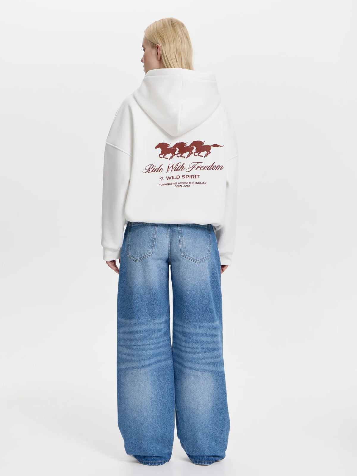 White oversized hoodie with back horse graphic and 'Ride With Freedom' text