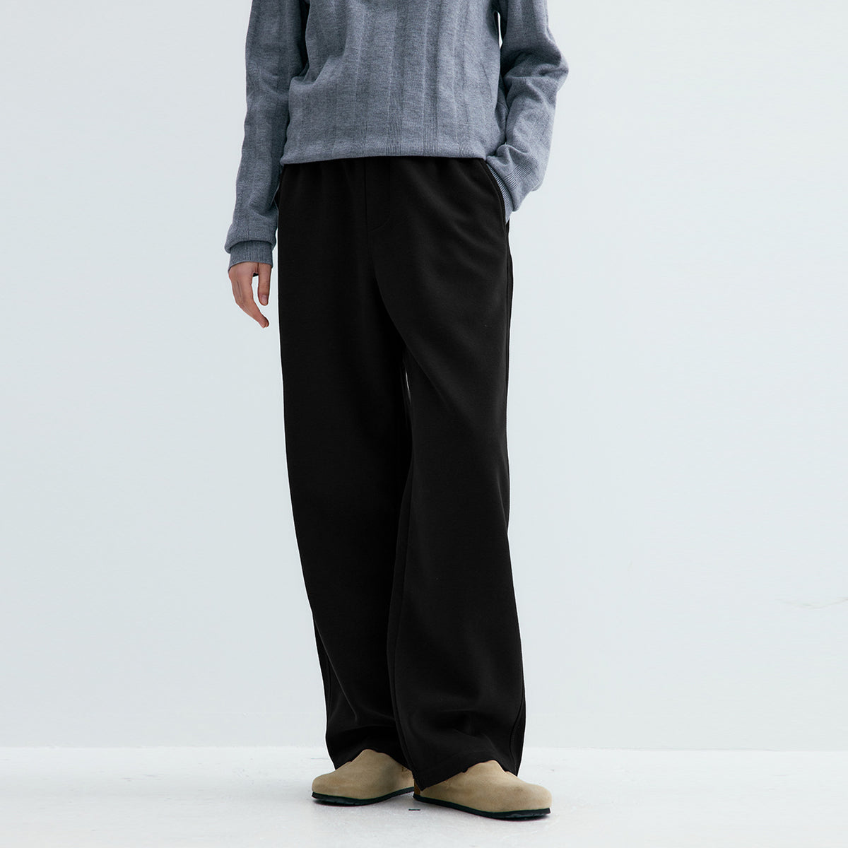 Black knit sweatpants with straight wide legs and elastic waistband