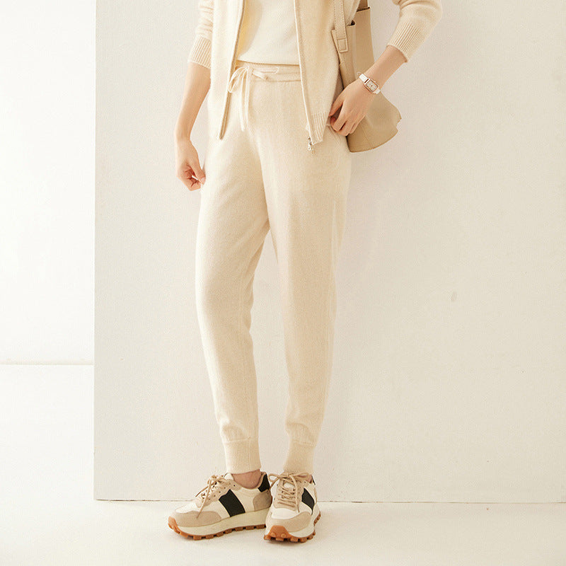 Light beige cashmere-knit jogger pants with drawstring waist and tapered slim legs