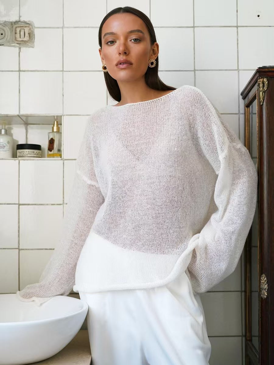 Light gray women’s loose knit sweater top with round neck and long sleeves, sheer texture