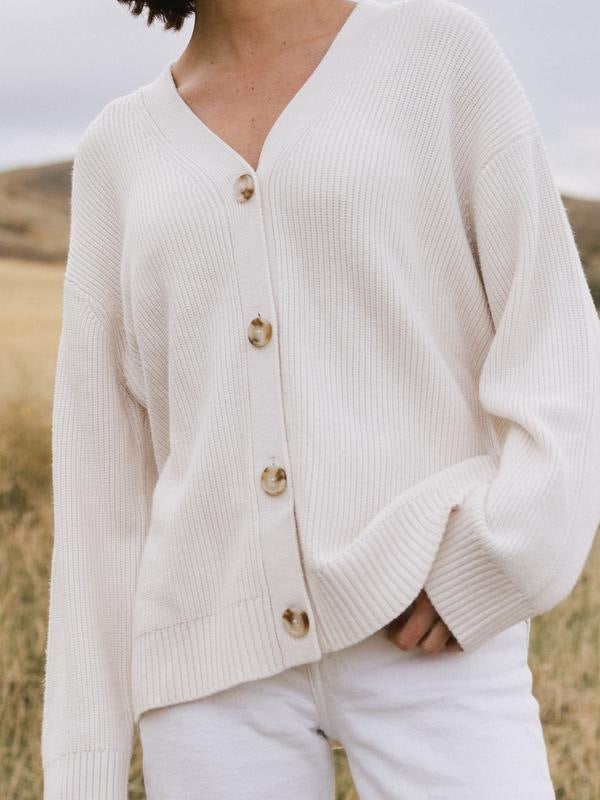 Ivory ribbed cardigan with a V-neck, large buttons, and long sleeves