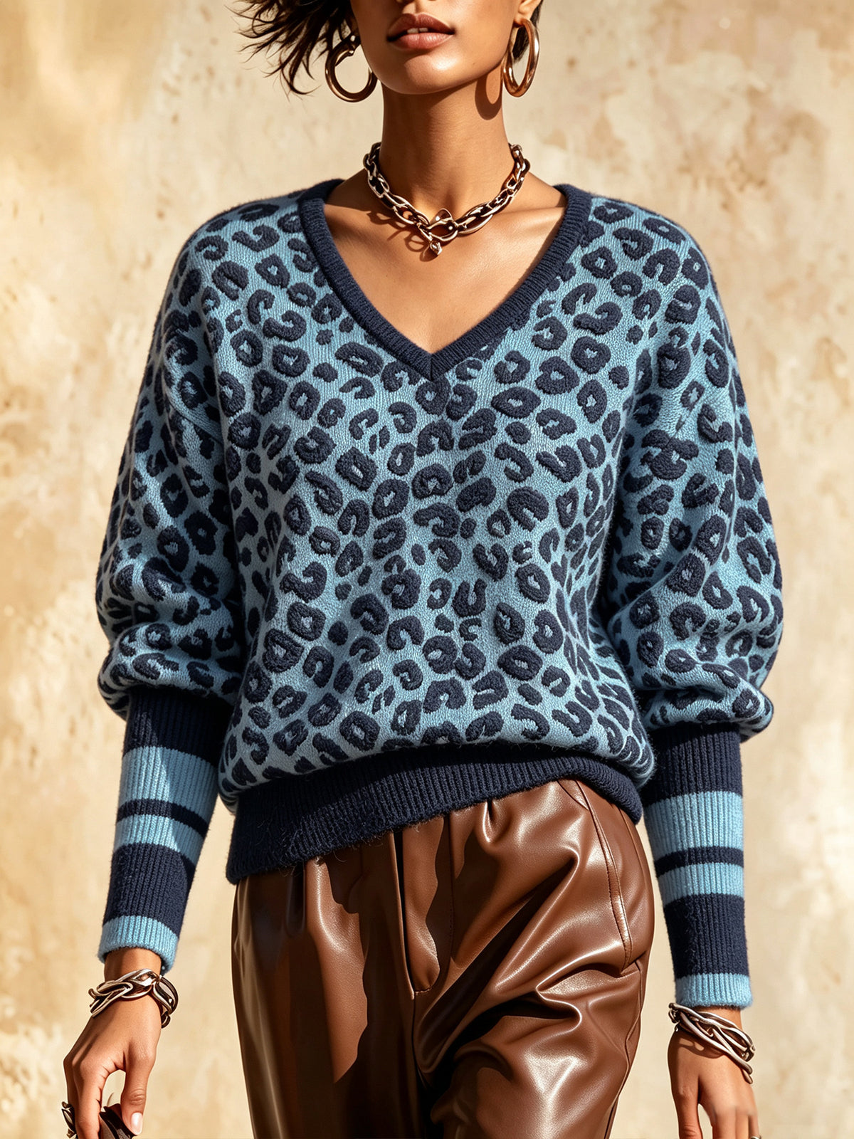 Sky blue leopard print V-neck knit sweater with striped cuffs and ribbed hem
