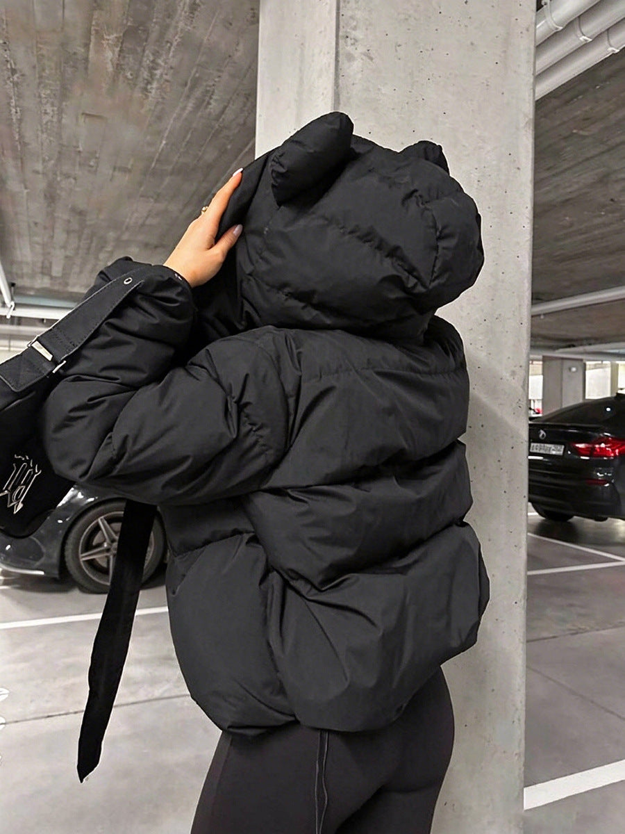 Back view of a black padded hooded jacket with rounded ear details and long drawstrings.