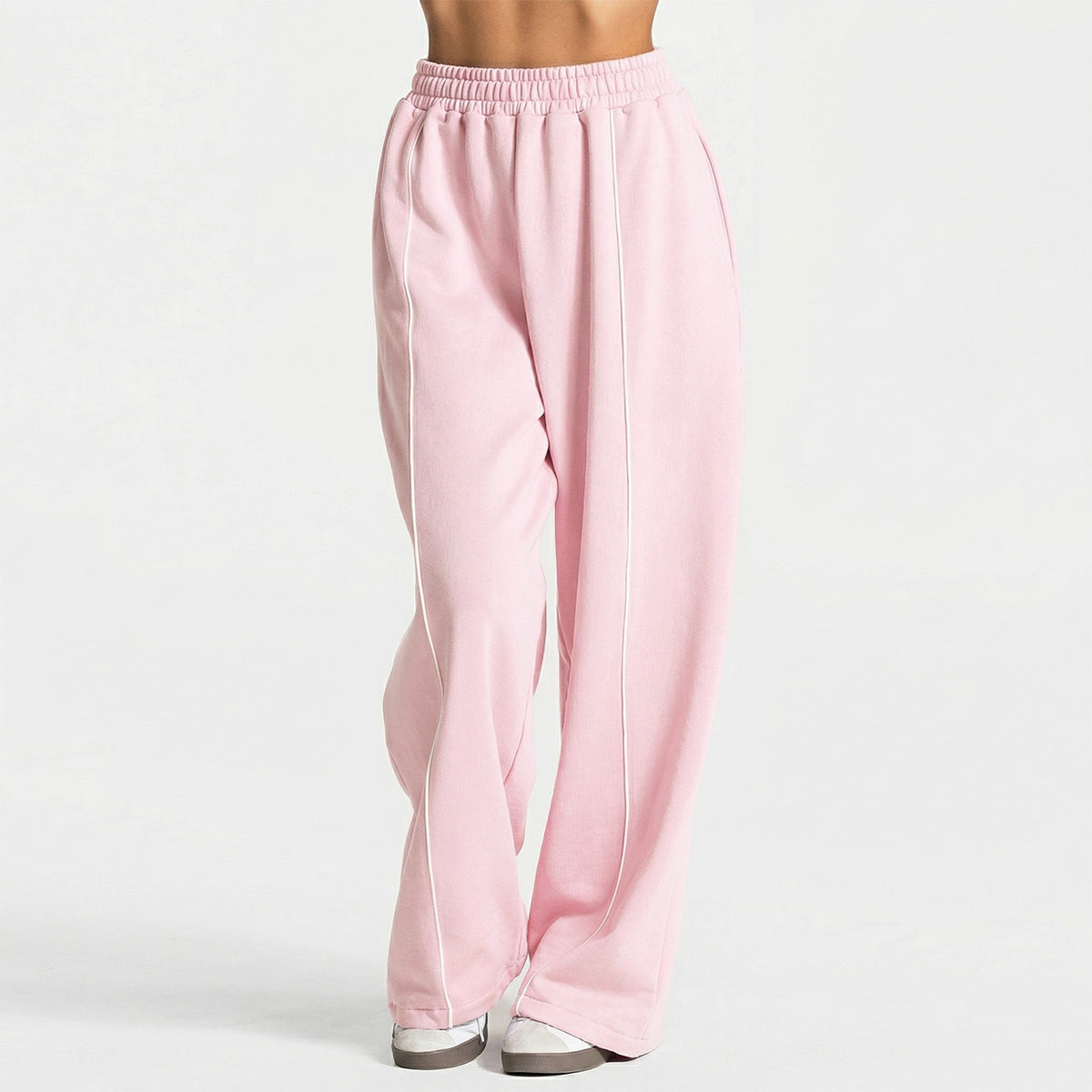 Light pink loose yoga pants with elastic waistband and vertical white contrast stripe