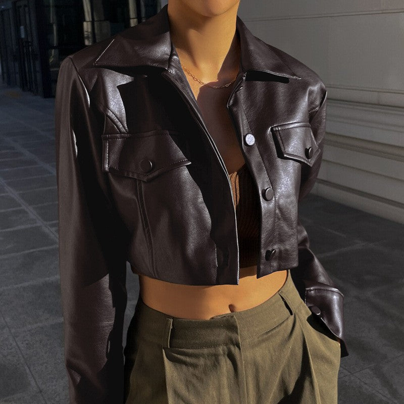 Brown cropped biker leather jacket with lapel, button front, flap pockets, and collar tabs