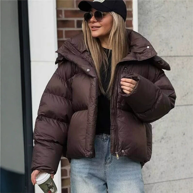 Brown quilted puffer jacket with hood, front zipper, and buttoned cuffs