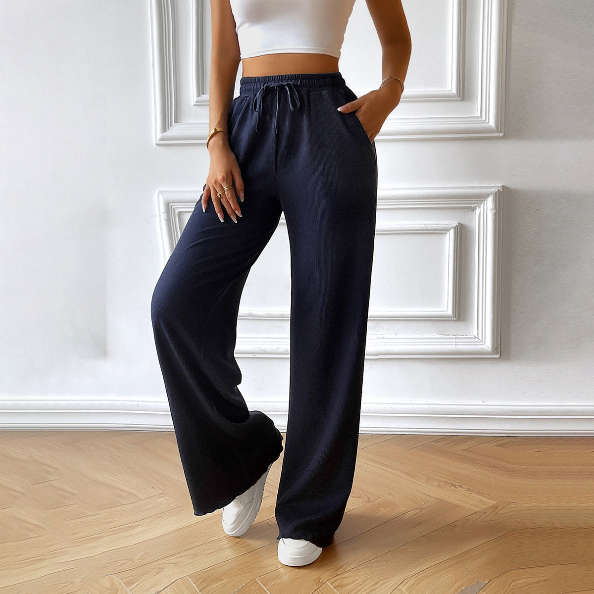 Navy blue wide-leg drawstring pants with elastic waist and relaxed drape