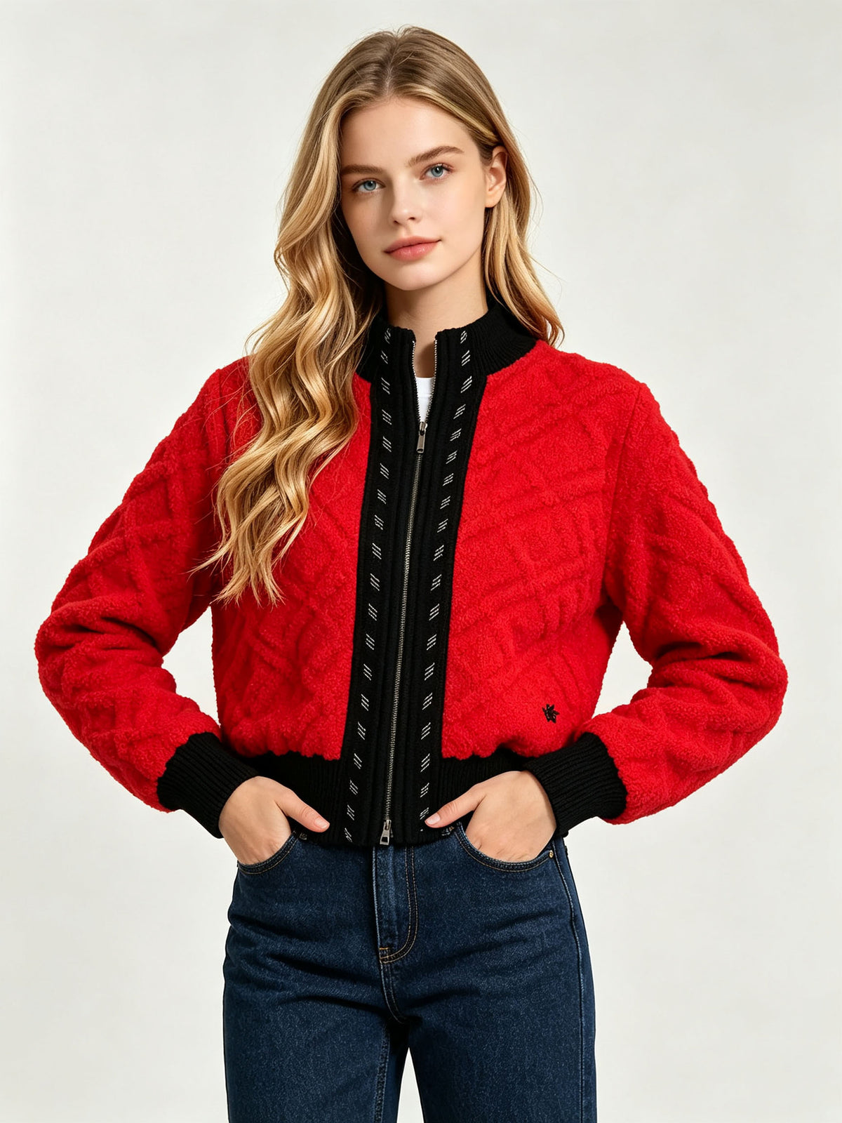 Red cable-knit zip cardigan with black stand collar and ribbed cuffs.