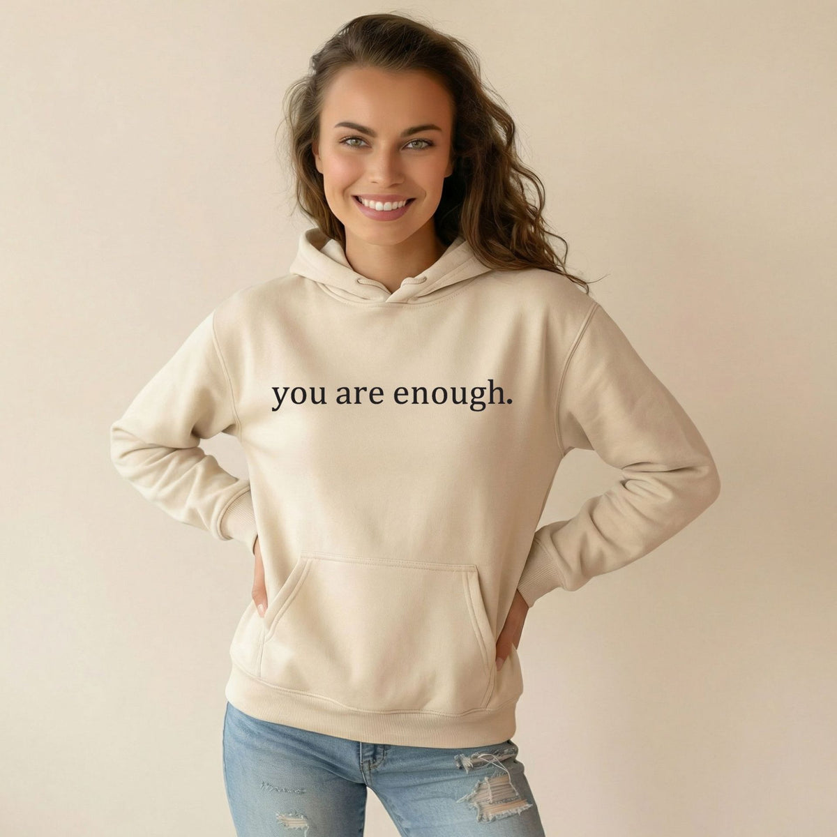 Cream women’s hoodie sweatshirt with hood, front pocket, and 'you are enough' print.