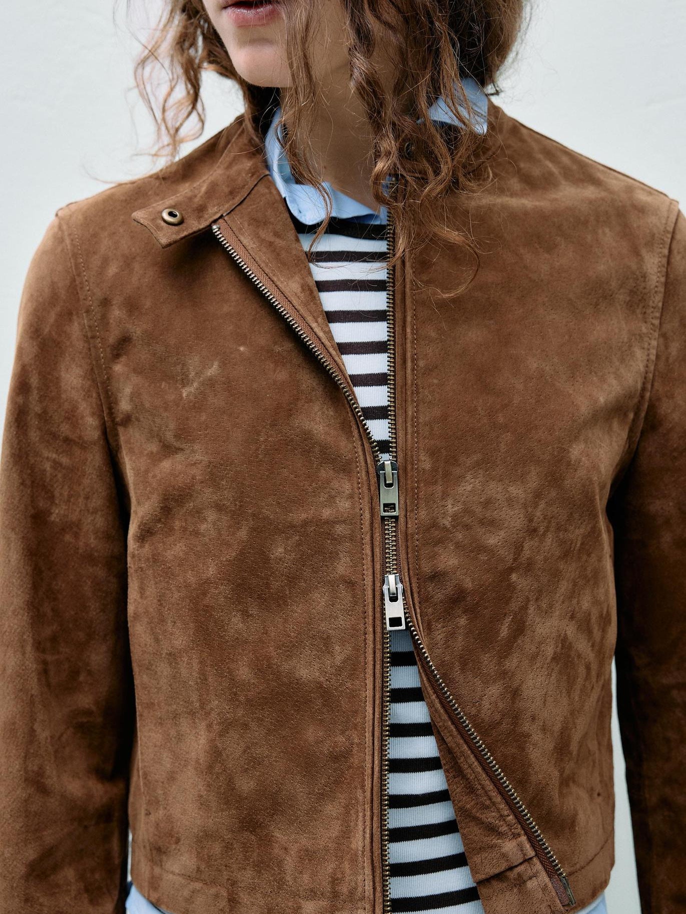 Brown faux suede fitted moto jacket with front zipper and snap shoulder detail