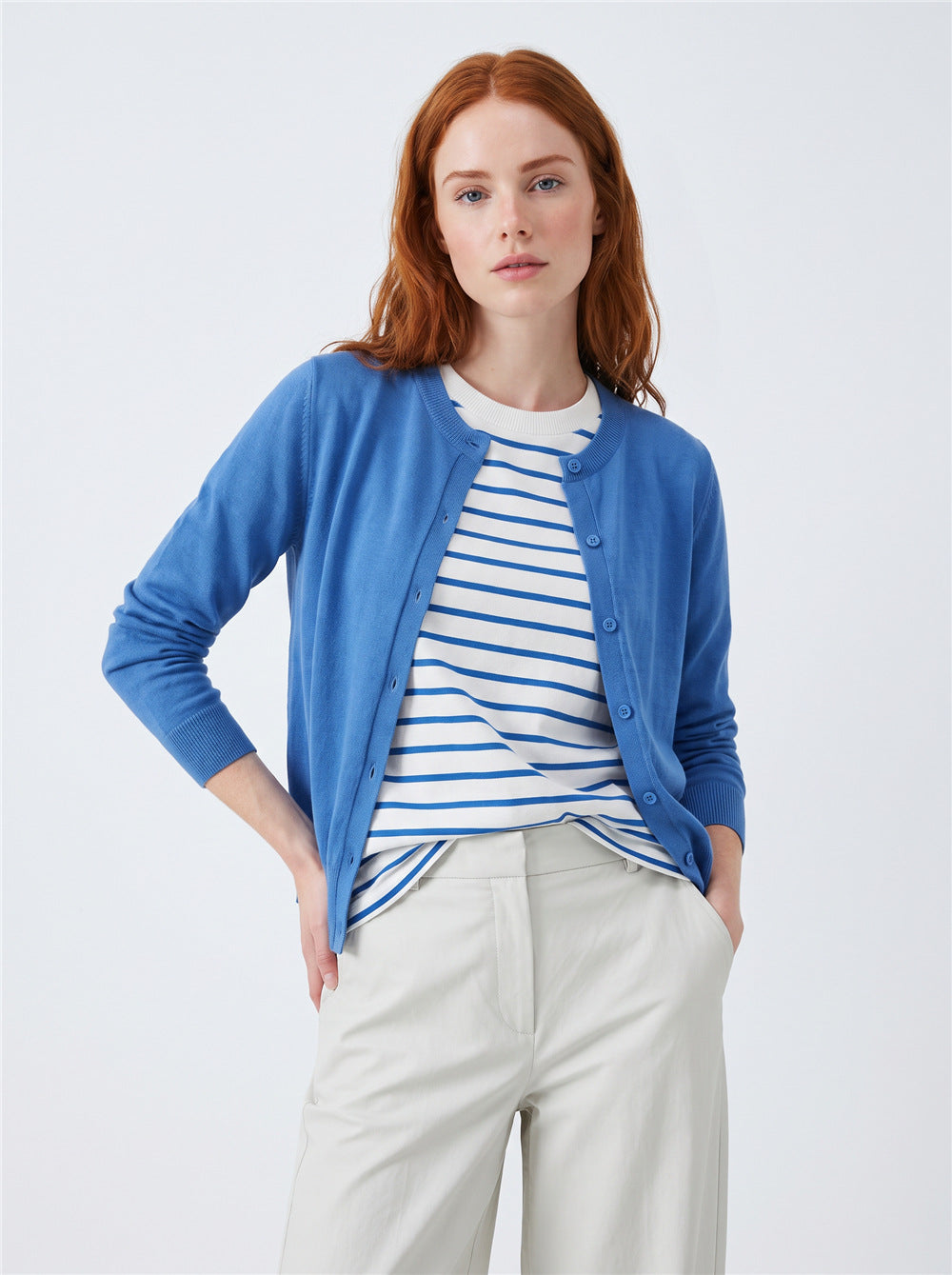 Women’s blue button-front cardigan sweater with faux striped tee underlayer