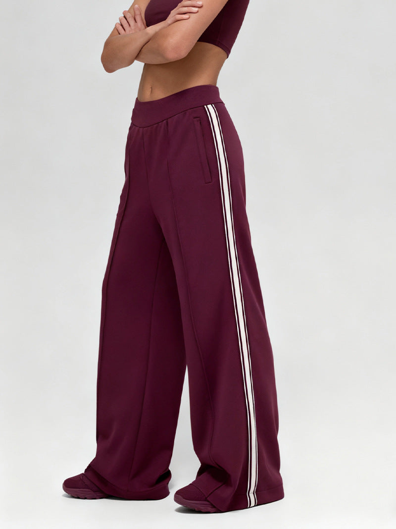 Wine red drape pants with white triple side stripes and roomy wide-leg fit