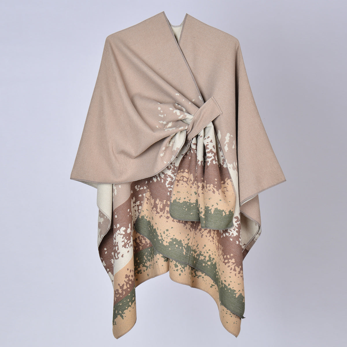 Faux cashmere print shawl, tan top with beige, sage, and dark splash pattern, draped.