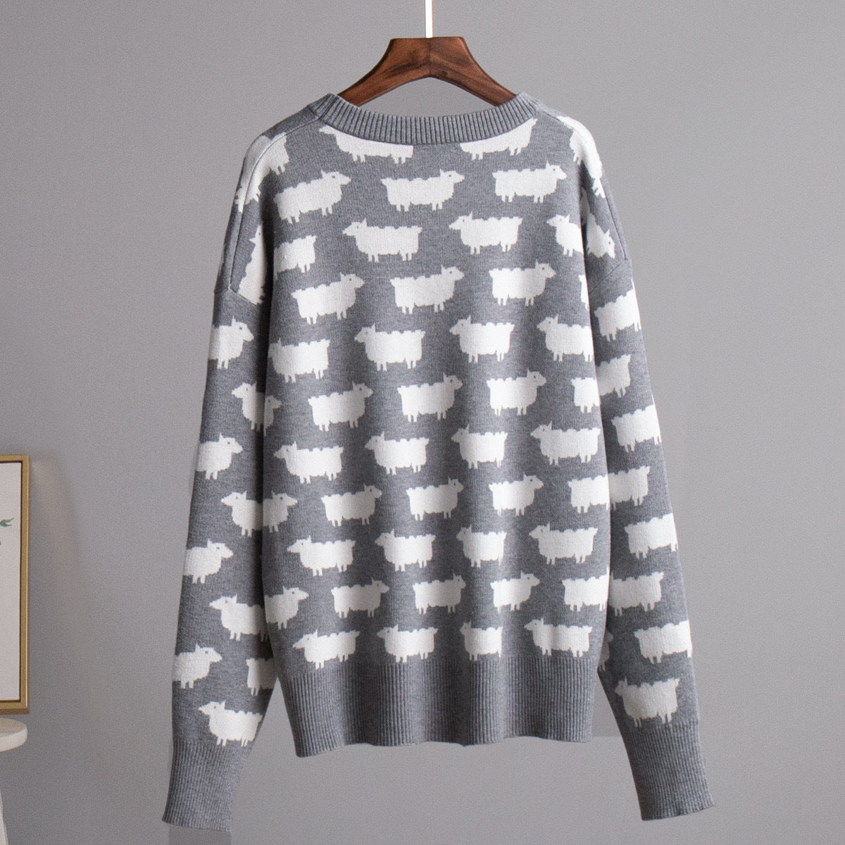 Women’s crewneck knit sweater, gray with white sheep pattern, long sleeves
