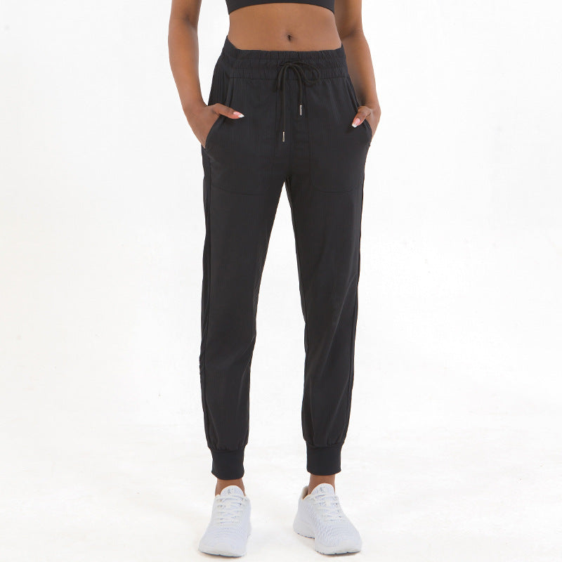 Black ankle jogger pants with drawstring waist and elastic cuffs, side pockets